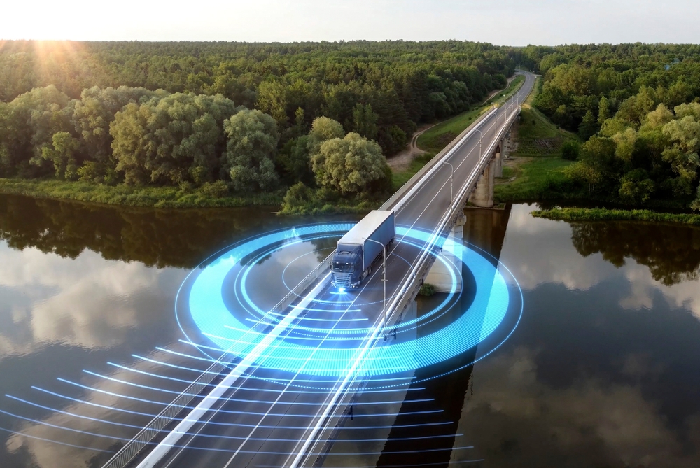 A semi-truck with a trailer, featuring an integrated Temperature Compensated Crystal Oscillator (TCXO) for precision navigation, is showcased on a highway. 